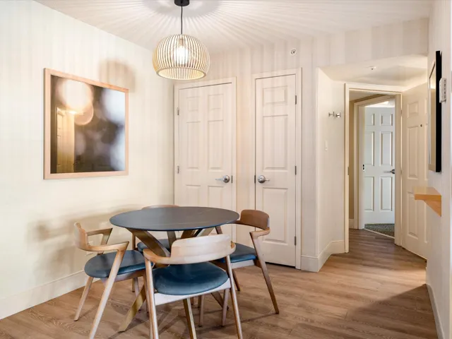 Dining space featuring light wood-type flooring and wallpapered walls