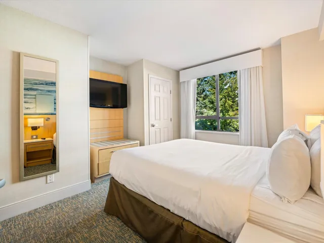 Bedroom featuring carpet floors and baseboards
