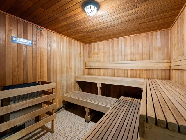 Relaxing sauna / steam room with wood ceiling and wooden walls