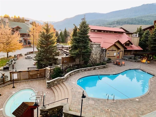 Community pool with a mountain view and a patio