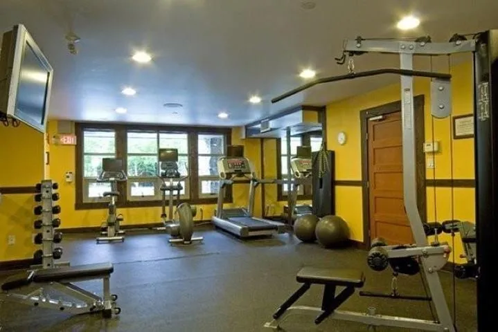 Exercise room with recessed lighting and baseboards