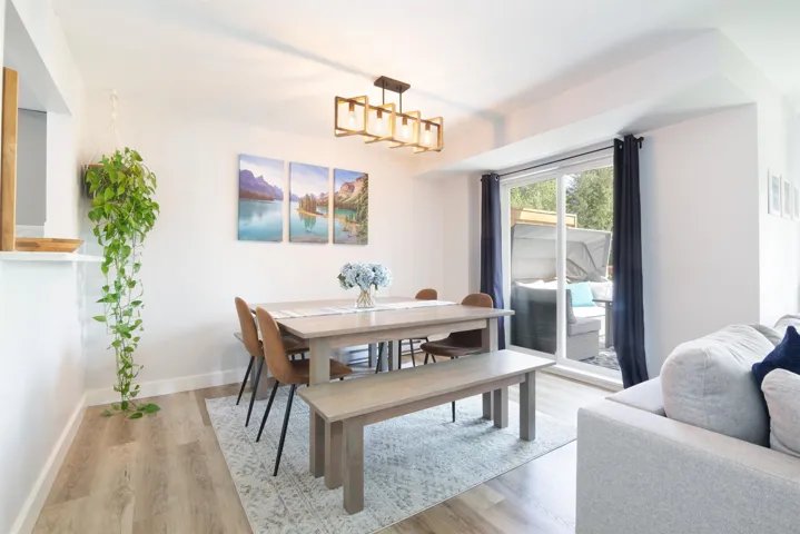 Dining room featuring a chandelier, light wood finished floors, and baseboards