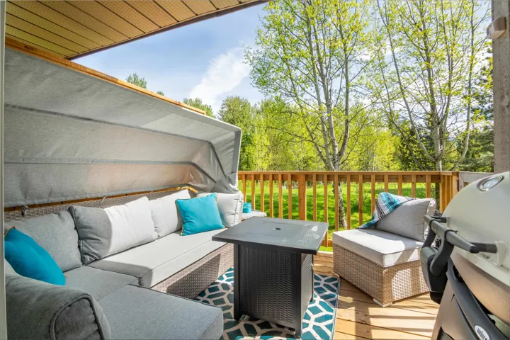 Deck with an outdoor living space and grilling area