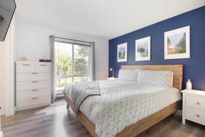 Bedroom with a baseboard radiator and wood finished floors