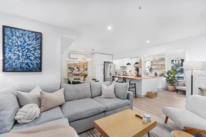 Living area with light wood-style flooring, recessed lighting, a chandelier, and an AC wall unit