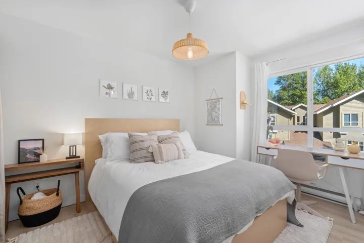 Bedroom with baseboard heating and wood finished floors