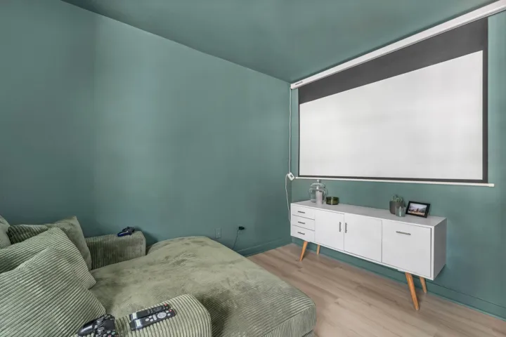 Home theater room with light wood-style flooring and baseboards