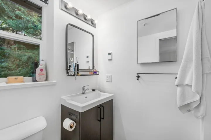 Half bathroom featuring vanity and toilet