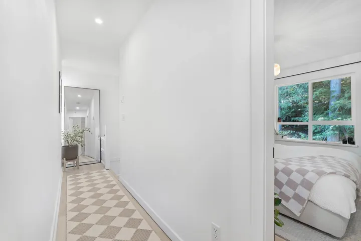 Corridor with recessed lighting and baseboards