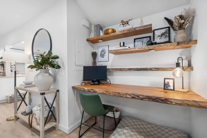 Office space featuring built in study area, light wood-type flooring, and electric panel