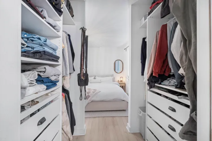Walk in closet with light wood-style flooring