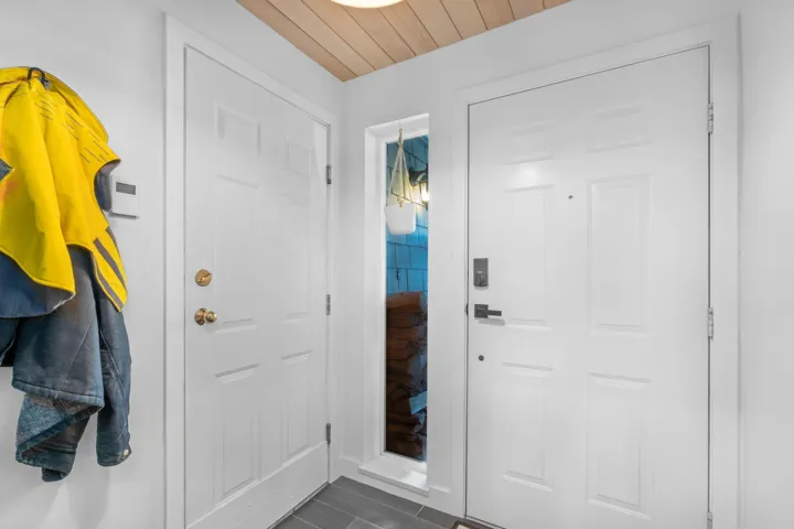 Entryway with wood ceiling and dark wood-style floors