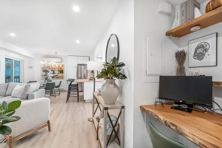 Office space featuring light wood-style floors, recessed lighting, and electric panel