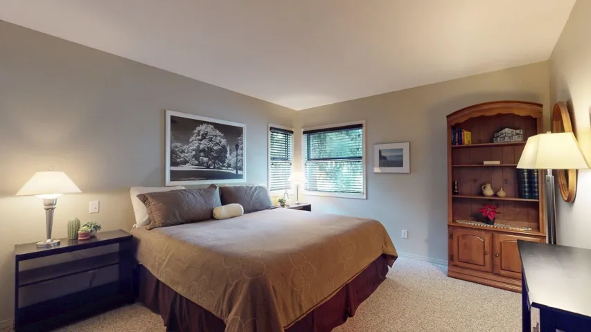 Bedroom featuring light colored carpet and baseboards