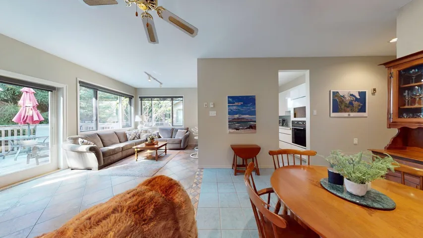 Dining room with light tile patterned floors and ceiling fan