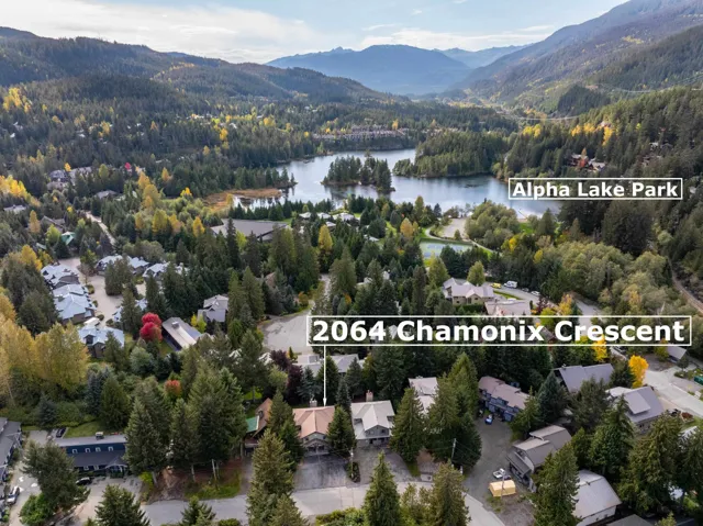 Aerial overview of property's location with a water and mountain view and nearby suburban area