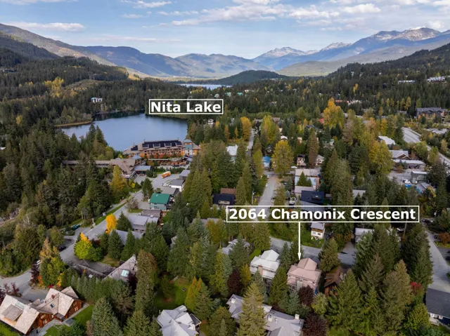 Aerial overview of property's location with a water and mountain view and nearby suburban area