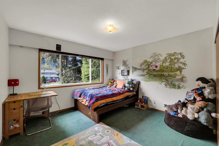 Bedroom featuring carpet floors and a textured ceiling