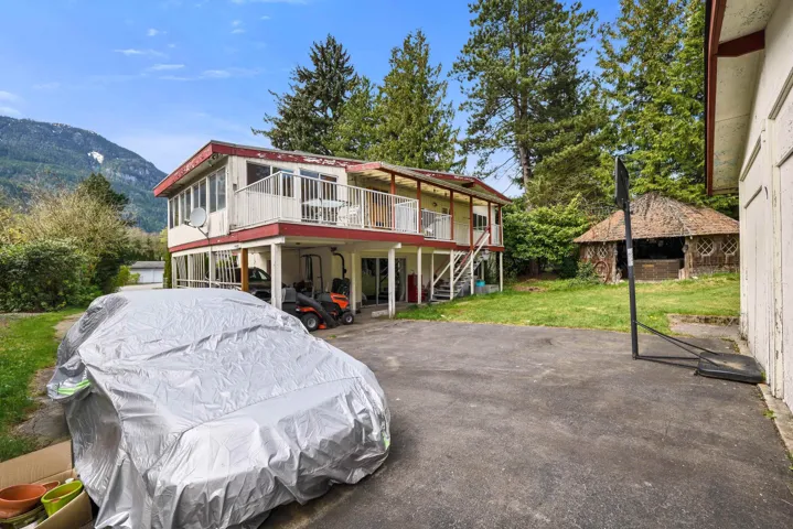 View of front facade with a front lawn and a deck with mountain view