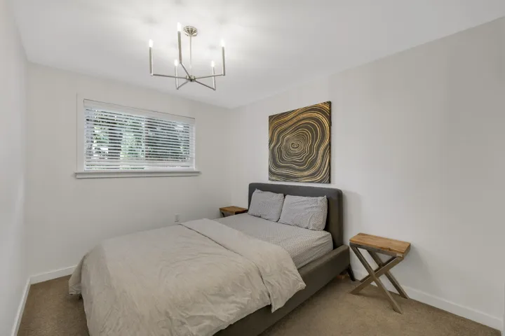 Bedroom with carpet flooring and a chandelier
