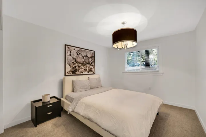 Bedroom featuring carpet flooring and baseboards