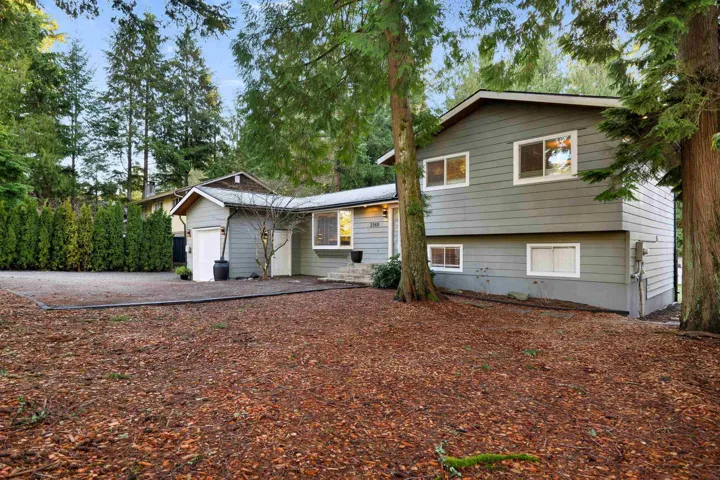 Tri-level home featuring an attached garage and driveway