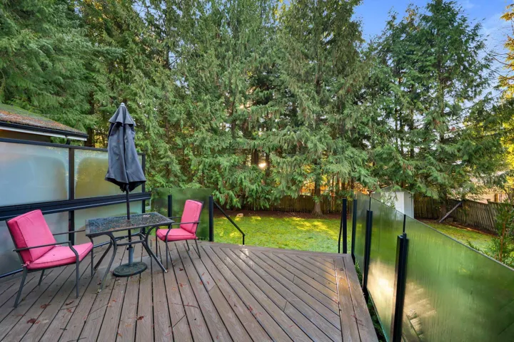 Wooden terrace featuring a fenced backyard and outdoor dining space