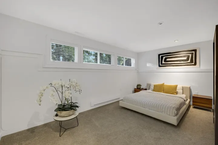 Bedroom featuring carpet and baseboard heating