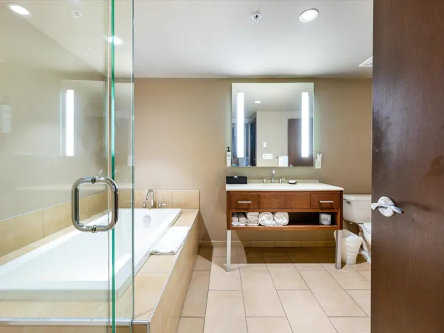 Bathroom featuring vanity, a bath, light tile patterned floors, recessed lighting, and a shower stall