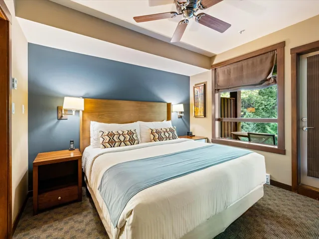Bedroom featuring ceiling fan and carpet