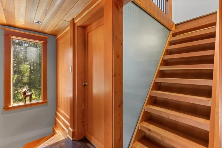 Staircase with wooden ceiling and wood finished floors