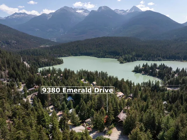 Aerial overview of property's location featuring a forest and a water and mountain view