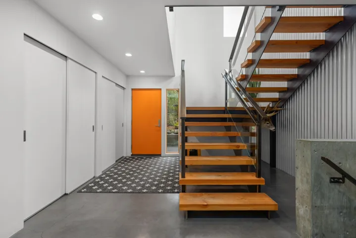 Stairway with finished concrete floors and recessed lighting