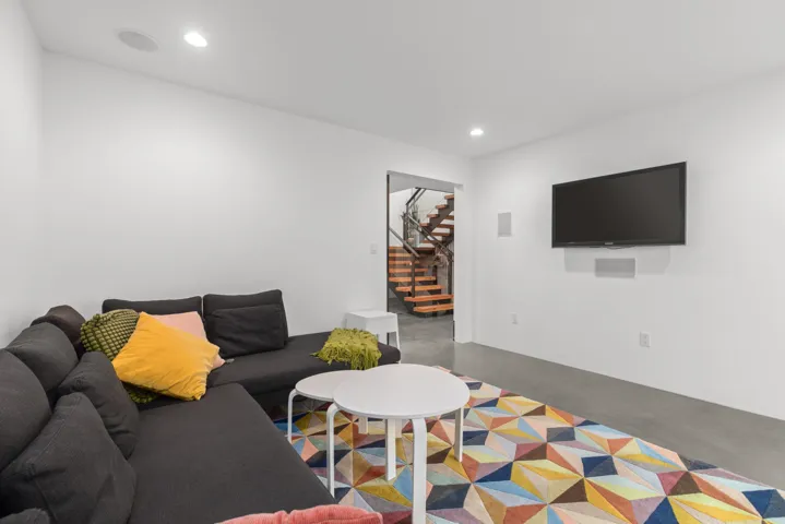 Living area featuring concrete flooring and recessed lighting