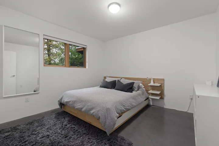 Bedroom featuring concrete floors