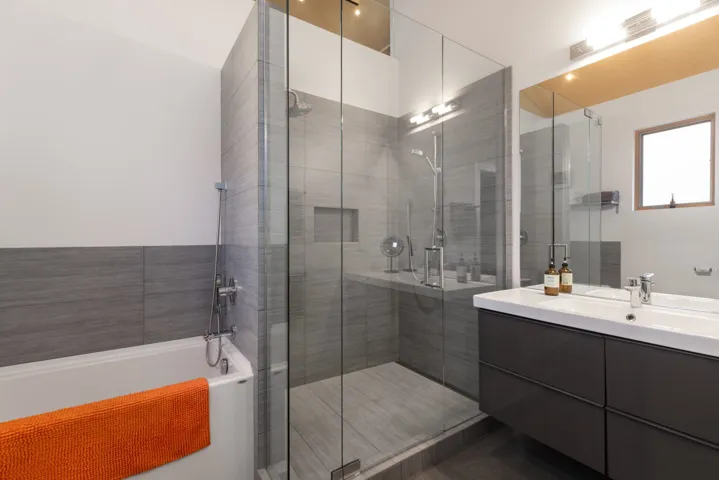 Full bath featuring vanity, a garden tub, and a shower stall