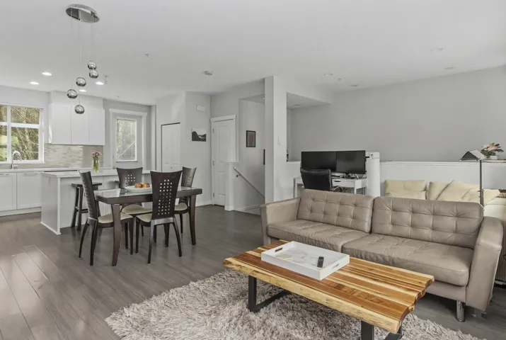 Open-concept living space with wood-finish flooring throughout