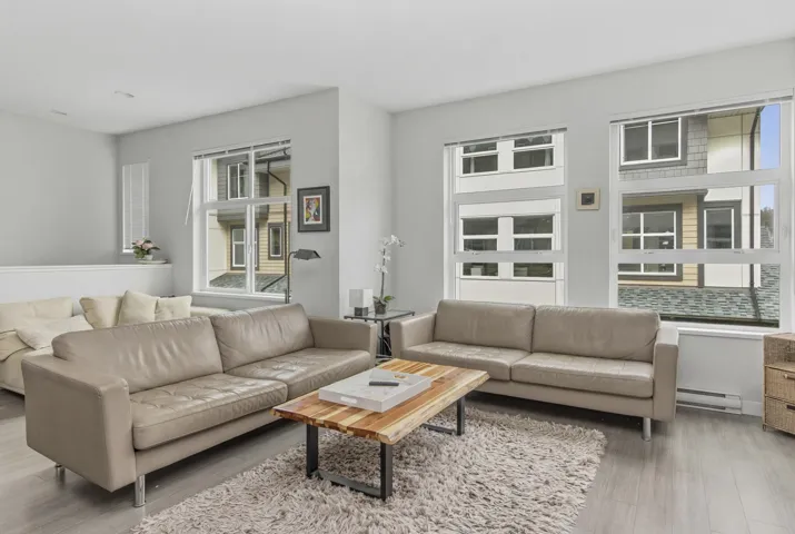 Bright living area featuring light wood-finish flooring