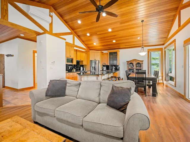 Living room with wooden ceiling, lofted ceiling, baseboards, ceiling fan, and recessed lighting