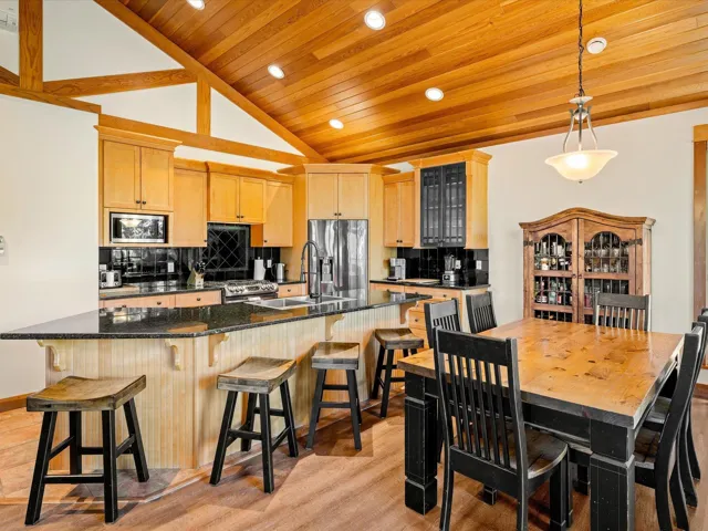 Kitchen with appliances with stainless steel finishes, light brown cabinetry, wood ceiling, a sink, and recessed lighting