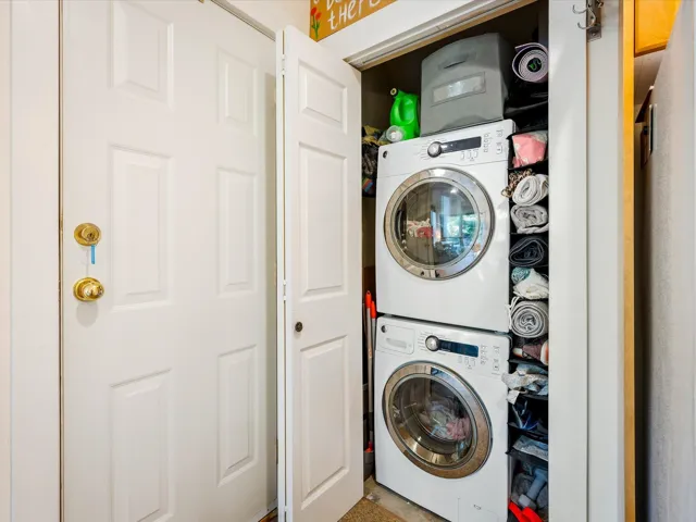 Laundry area with stacked washer / dryer