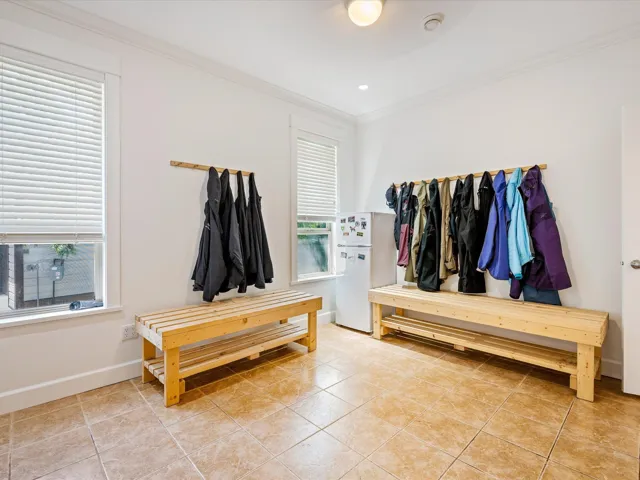Mudroom with ornamental molding, baseboards, and light tile patterned floors