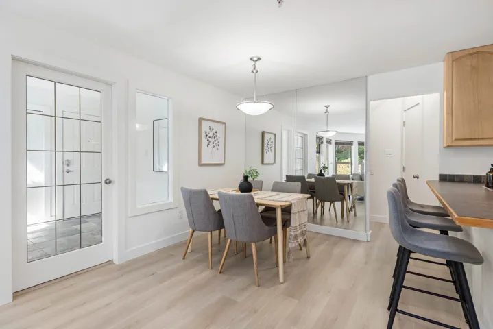 Dining space with light wood-style floors and baseboards