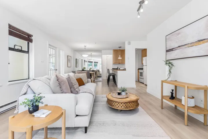 Living room featuring light wood-style flooring and baseboards