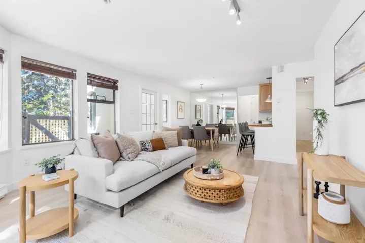 Living area featuring light wood-type flooring and baseboards