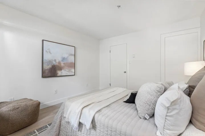 Bedroom with light wood-style floors and baseboards