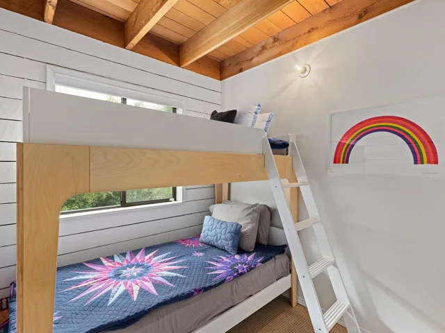 Bedroom featuring multiple windows and a wood ceiling with exposed beams