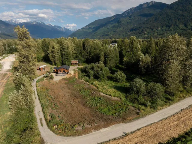 View of property location with a mountain backdrop and a heavily wooded area
