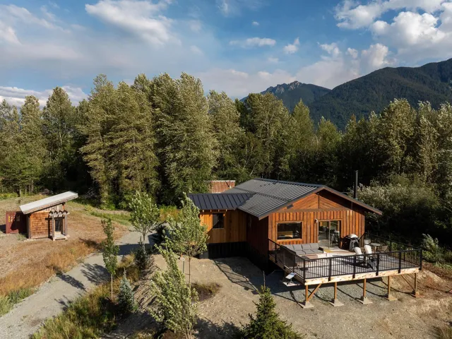 View from above of property with a forest and mountains