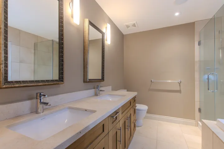 Bathroom with double vanity, a stall shower, light tile patterned floors, and recessed lighting